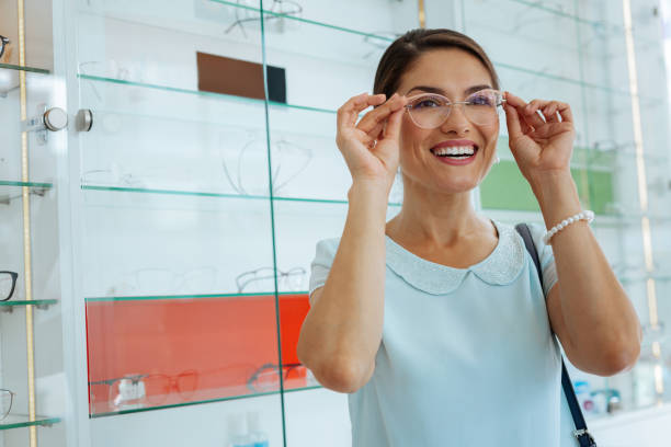 istock Joyful happy woman trying some eyeglasses on 1168896859