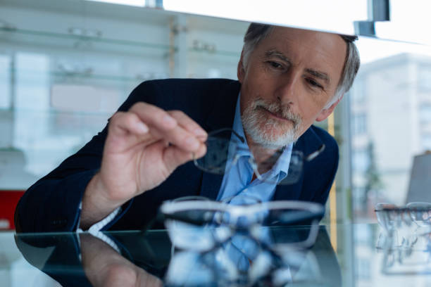 istock Positive mature man looking at the eyeglasses 1168896886