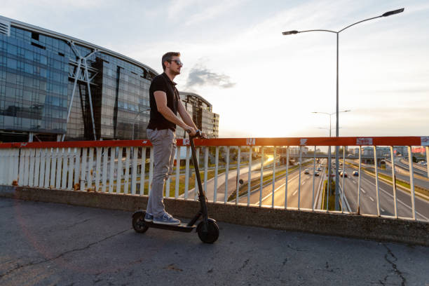 istock Commuter riding e-scooter on the elevated walkway at dusk 1168896903