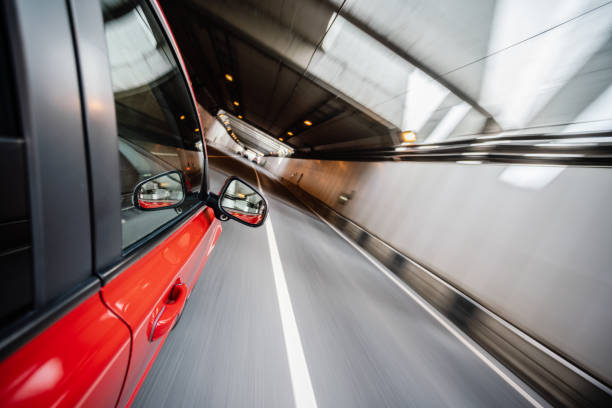 istock Driving a red car in the urban tunnel 1168897212