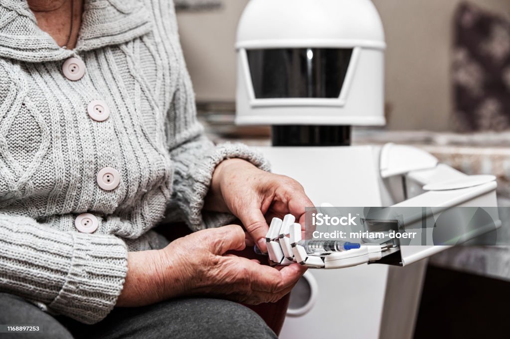 autonomous caregiver robot is holding a insulin syringe, giving it to an senior adult woman in her living room, concept ambient assisted living Robot Stock Photo