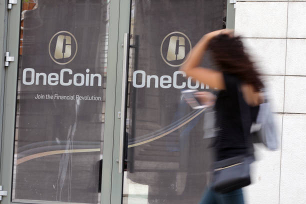 OneCoin cryptocurrency Sofia, Bulgaria - 12 May, 2019: A woman passes by the office of OneCoin cryptocurrency founded by Ruja Ignatova. ponzi scheme stock pictures, royalty-free photos & images