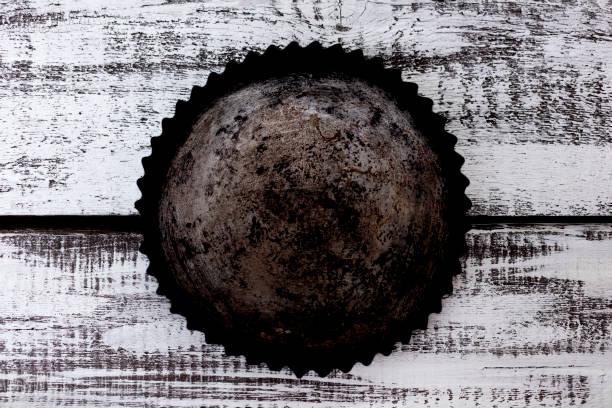 Old vintage baking tins on wooden background.
