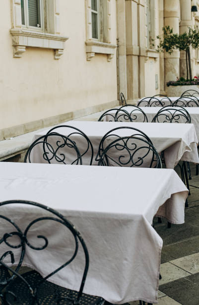 istock row tables cafe outside street forged chairs 1168904315