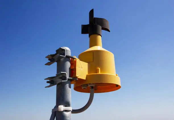 Wind speed measuring device on display. Anemometer on blue background. Bologna, Emilia-Romagna