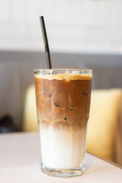 istock Iced coffee glass with black straw on table in cafe and restaurant. 1168907117