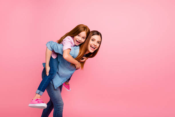 Funny attractive little lady and her mom spending weekend together wear casual clothes isolated pink background Funny attractive little lady and her, mom spending weekend together wear casual clothes isolated pink background little redhead girl stock pictures, royalty-free photos & images