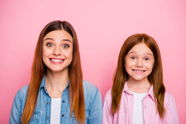 close up photo of charming girls looking with beaming smile isolated over pink background - offspring child toothy smile beautiful imagens e fotografias de stock