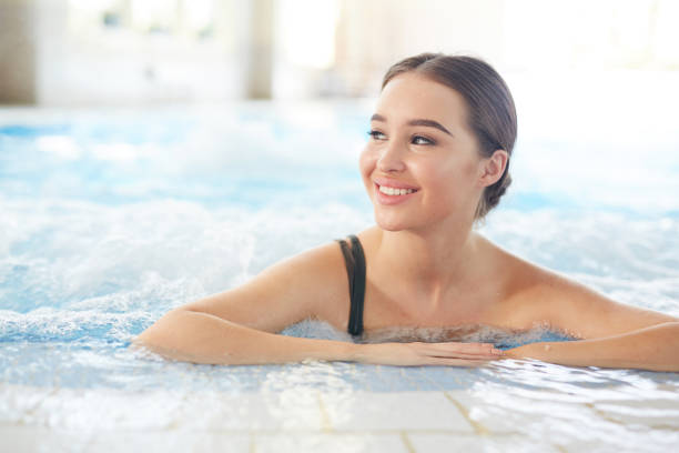 istock Smiling Woman in Swimming Pool 1168908736