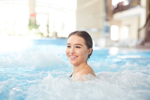 istock Smiling Woman Enjoying Hot Tub 1168908739