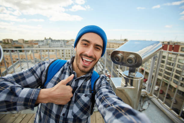 istock Tourist Thumbs Up on Rooftop 1168909402