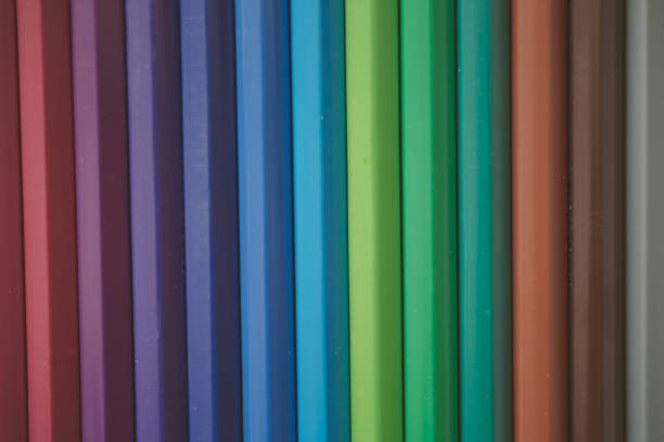 Close up view of colored pencils as background for design. Back to school. Multicolored background and texture.