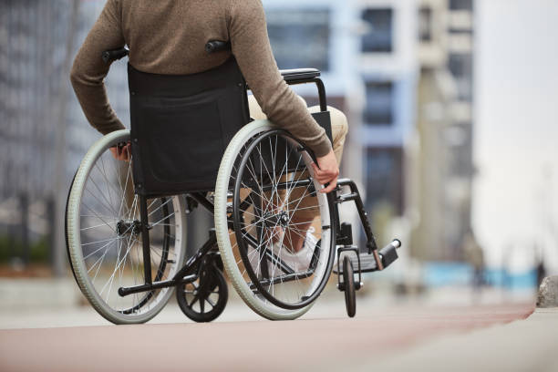 istock Unrecognizable disabled man in casual clothing using assistive device for personal mobility because of problem with legs 1168910262
