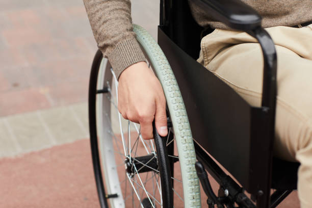 istock Close-up of unrecognizable man practicing ride in modern wheelchair while recovering after spine trauma 1168910464