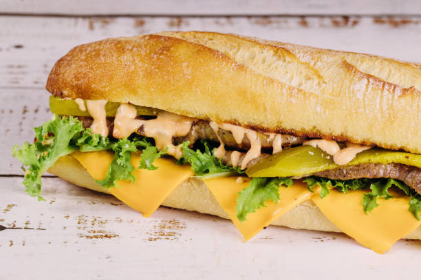 istock Sub sandwich with cheese and pickles on a white background. 1168910995