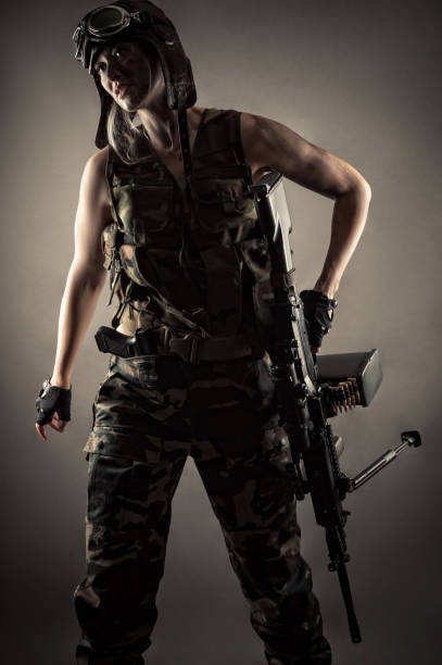 istock female soldier in uniform with machine gun 1168911633