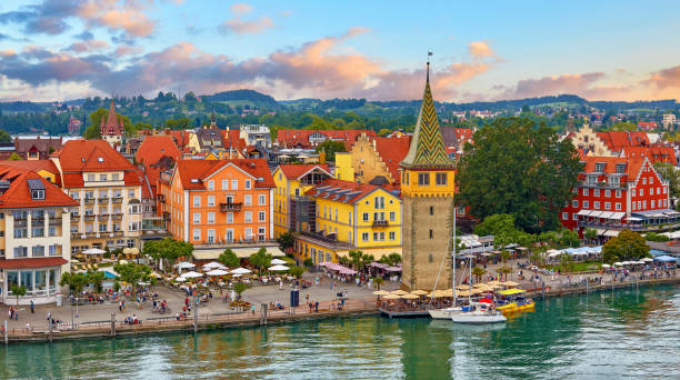 Lindau, Germany. Antique town in Bavaria at Bodensee Lake Lindau, Germany. Antique Bavarian town in Bavaria at coastline of Lake Constance (Bodensee). Habour along embankment with traditional houses and tower. Sunset evening landscape. bodensee stock pictures, royalty-free photos & images