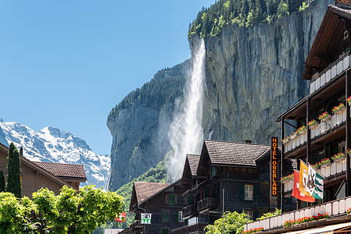 Lauterbrunnen, Switzerland - June 17, 2019: Townscape in Lauterbrunnen with Staubbach Falls in the Bernese Oberland in Switzerland