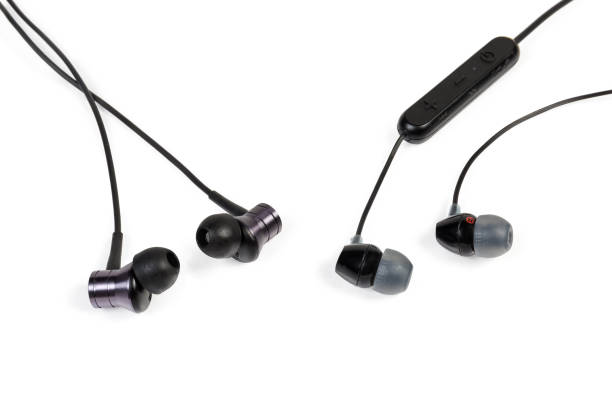 istock Different black in-ear earphones close-up on white background 1168915842