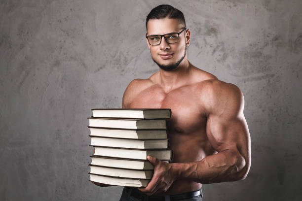 smart-and-muscular-man-with-a-heap-of-books.jpg