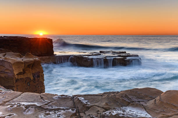 istock Clear Skies and Rocky Coastal Sunrise 1168918384