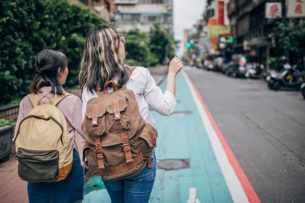 istock Two girls students walking on the street 1168919859