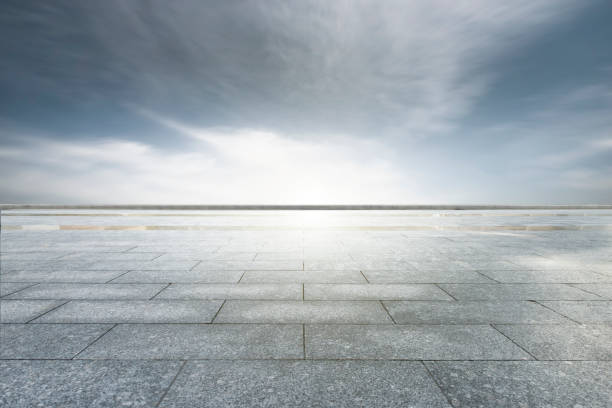 istock Dark clouds and orange clouds after sunset, unmanned square made of marble blocks 1168924450