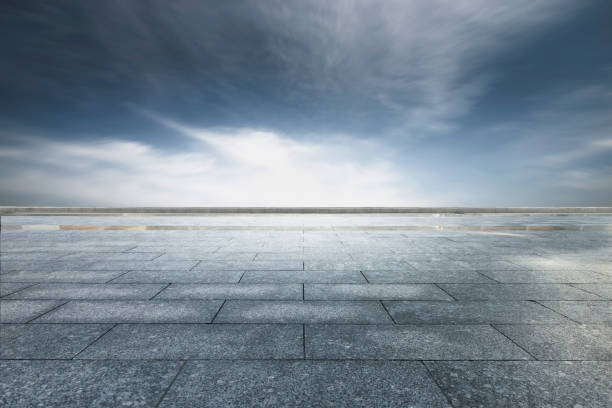 istock Dark clouds and orange clouds after sunset, unmanned square made of marble blocks 1168924502