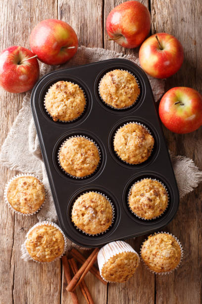 istock Rustic style fresh apple muffins with cinnamon close-up on the table. Vertical top view 1168928480