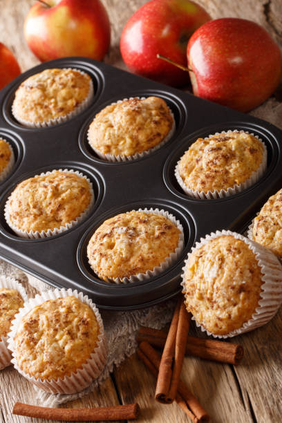 istock Fresh apple muffins with cinnamon close-up in a tray. vertical 1168928599