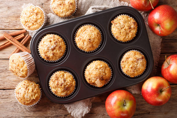 istock Rustic style fresh apple muffins with cinnamon close-up on the table. Horizontal top view 1168928679