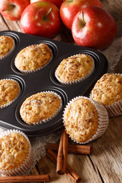 istock Rustic style fresh apple muffins with cinnamon close-up on the table. vertical 1168928808