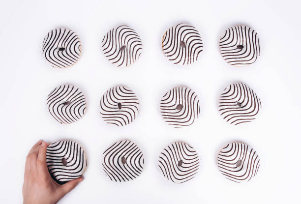 istock Striped donuts on a white background. Stylish minimal concept 1168929336