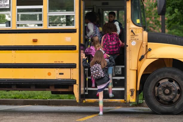 istock Diverse group of happy children getting on school bus 1168934161