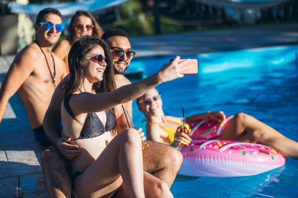 istock Selfie with friends at a poolside party 1168934265