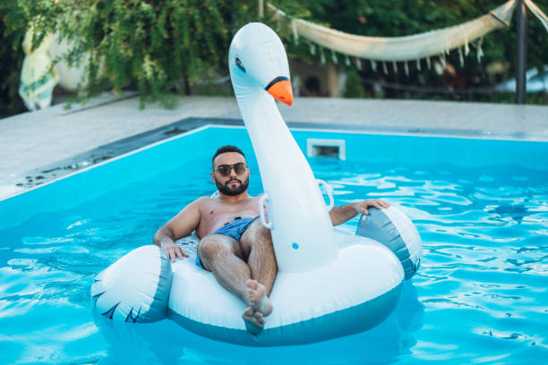 istock Carefree man on float swan 1168935924