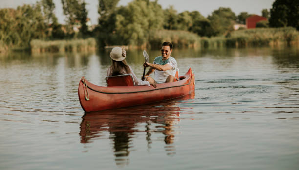 istock Loving couple rowing on the lake 1168936260