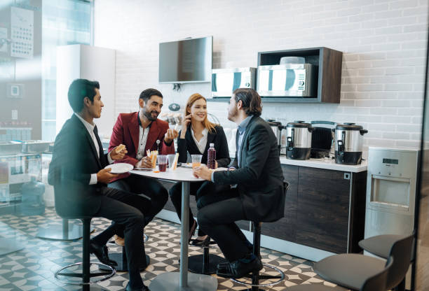 istock Millennial Latin coworkers taking a break at work, eating snack and chatting. 1168936550