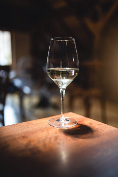 istock Wine glass with white wine on a bar table 1168939539