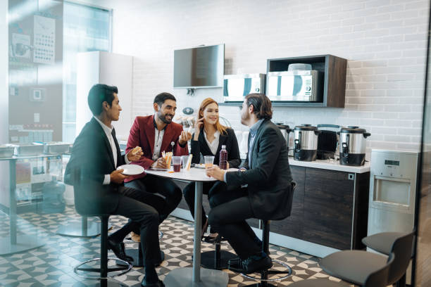 istock Millennial Latin coworkers taking a break at work, eating breakfast and chatting. 1168939633