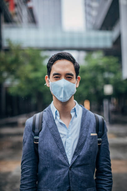 istock Gentleman with pollution mask on the street 1168939681