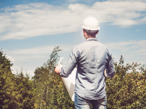 Man holding paper project in the park