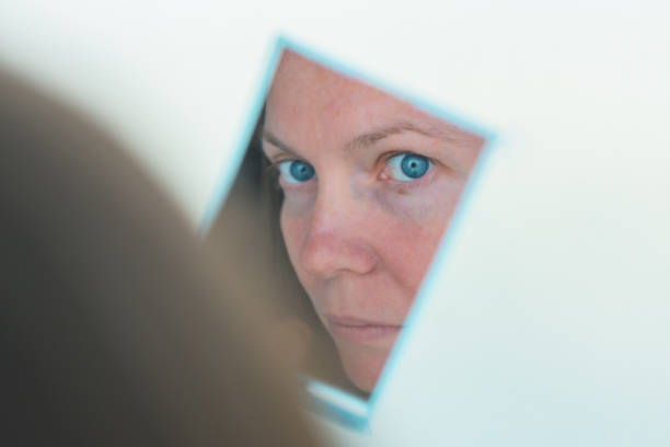 istock Businesswoman looking at her pocket mirror 1168940893