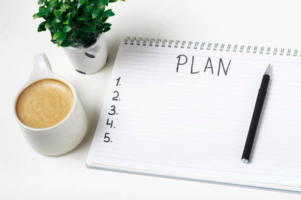 Inscription Plan in notepad, close-up, top view, concept of planning, goal setting