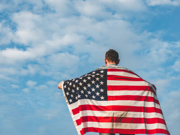 istock Handsome, young man waving an American flag 1168943033