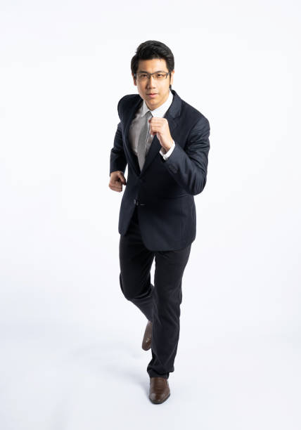 istock Asian businessman in suit running isolated on white background 1168944463