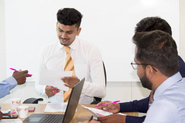 istock Businessmen reading document at office meeting 1168944642