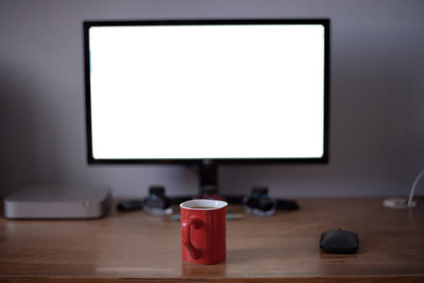 istock Home office wooden desk. Shallow depth of field, lit by computer screen. 1168944707