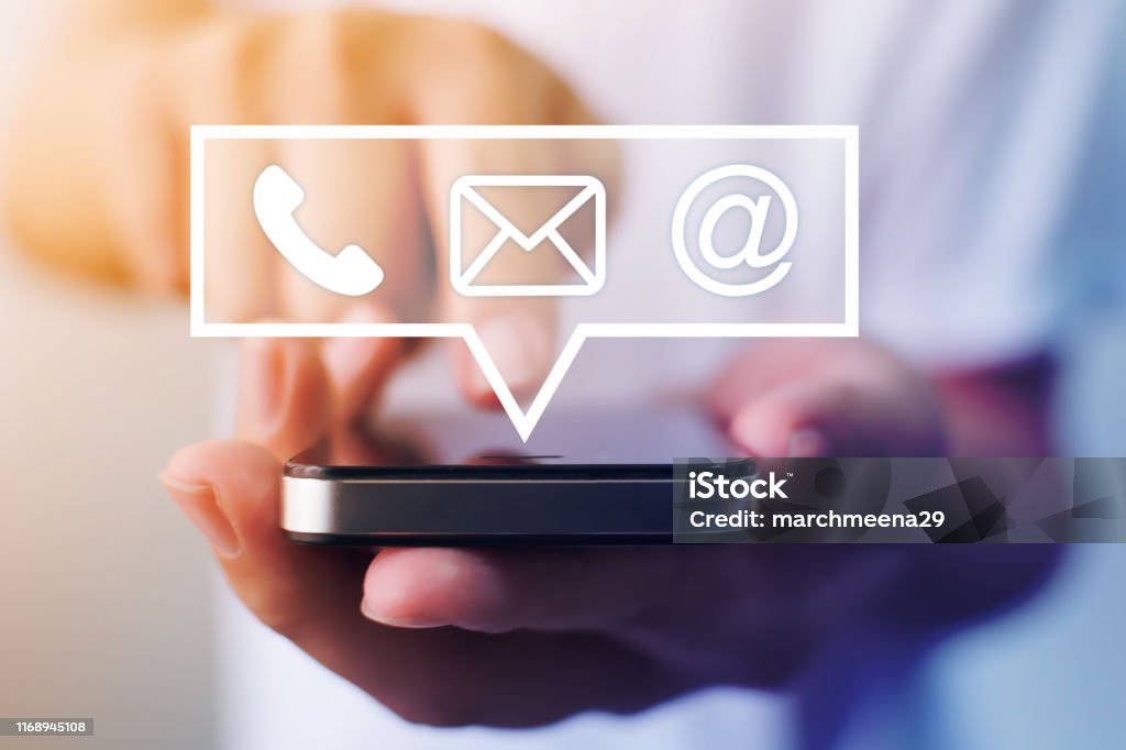 Close-up image of male hands using smartphone with icon telephone email mobile phone and address. Contact us connection and e-mail marketing concept Connection Stock Photo