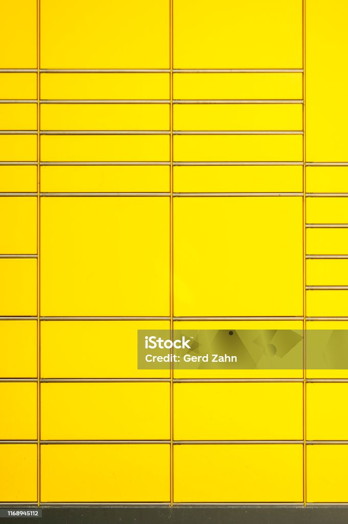 Detail of a parcel station in Germany, the lines of the chrome strips of the different sized compartments form an abstract pattern with interruptions as background Mail Stock Photo